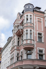 Ornate European architecture featuring pastel colored facade, tower windows, and classic design details