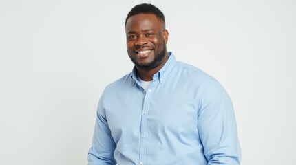 Handsome overweight businessman in sky blue collared shirt standing with arms crossed in corporate portrait style
