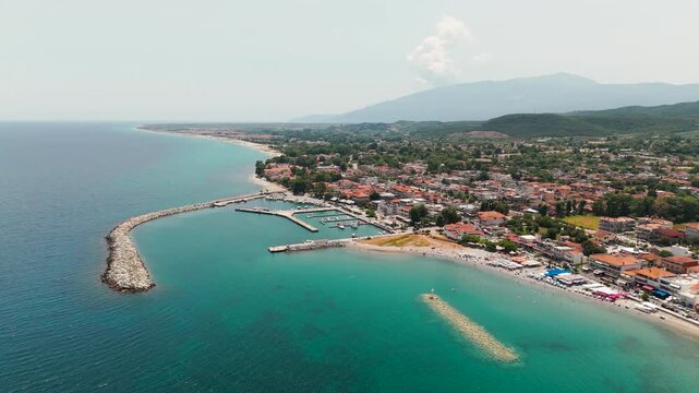 Aerial Drone Shot Panning Over Aegean Sea Away From Platamon Town, Pieria, Greece On A Sunny Summer Afternoon.