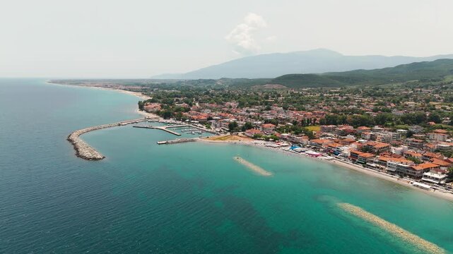 Aerial Drone Panning View of Platamon Coastal Town and Aegean Sea, Pieria, Greece on a Sunny Summer Afternoon.