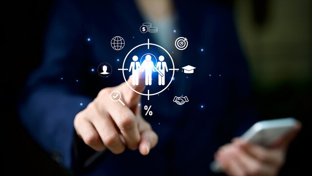 Businessman pointing at digital target audience with marketing icons, customer data, and analytics technology. Concept of business strategy, customer targeting, and digital marketing.
