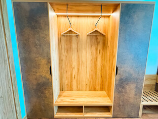 Wardrobe with hangers. Storage, organization, and hotel room furniture.