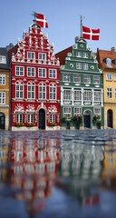Fototapeta premium Colorful historical buildings, adorned with intricate details, reflect in a glistening puddle on a sunny day.