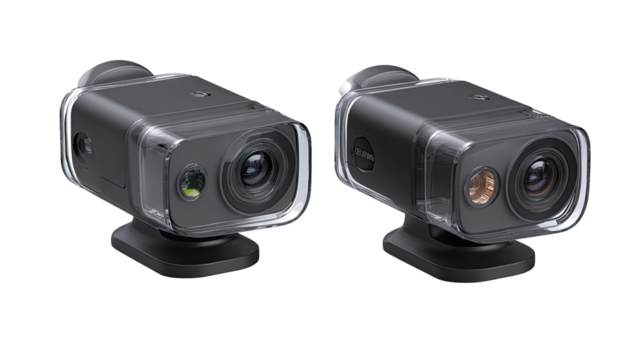 Two similar dark gray digital cameras, encased in clear protective housings.  Each camera features multiple lenses and a small, dark gray base