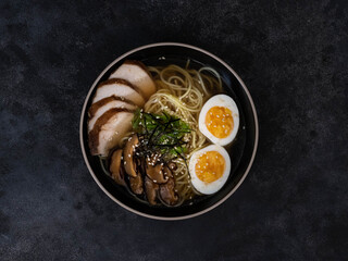 A vibrant and inviting ramen bowl featuring succulent chashu pork, perfectly softboiled eggs, and...