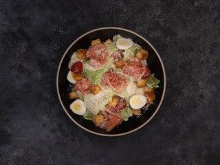 Enjoy a colorful Caesar salad with salmon,lettuce leaves, quail eggs, fresh veggies, cherry, and...