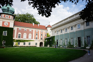 Historic courtyard in Lancut Poland featuring classic architecture and lush greenery