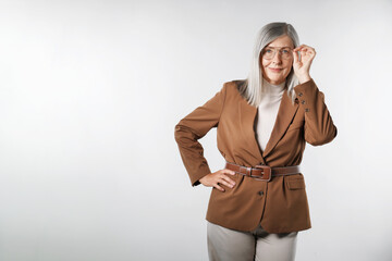 Portrait of beautiful senior woman on light background. Space for text