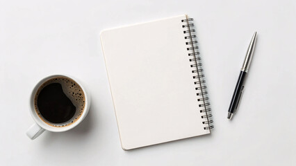 Minimalist workspace featuring white coffee cup with foam, open spiral notebook, black pen on clean white surface