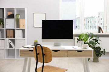 Stylish workplace with modern computer and stationery on white table in office