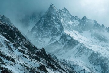 Obraz premium Majestic snow-capped mountains in a dramatic landscape