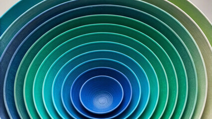Concentric Circles of Blue and Green Ceramic Bowls Nested Together teal