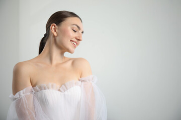 Dreams come true. Woman in beautiful wedding dress at home, space for text