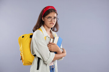 Student worried about her exam result on gray background. Space for text