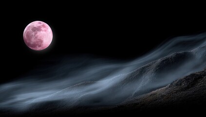 Pink moon over a misty mountain range.