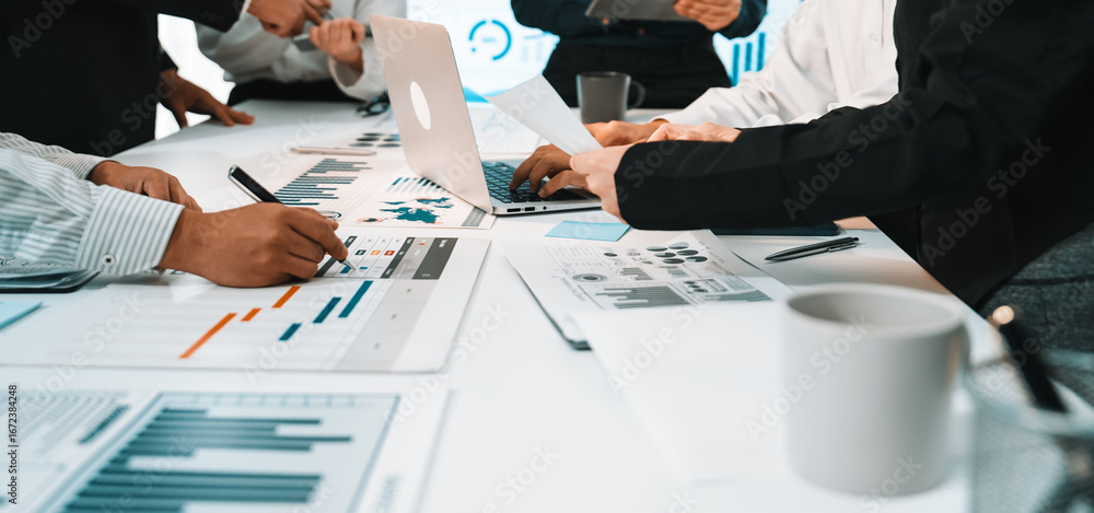 Poster a diverse group of professionals collaborates in a modern office setting, analyzing charts and data 