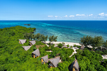 Eco bungalows nestled in the lush greenery of tropical Chumbe Island, Zanzibar, overlooking the...