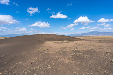 The shifting sands near Olduvai Gorge in Tanzania, a unique natural dune that slowly moves across the landscape under wind and time.
