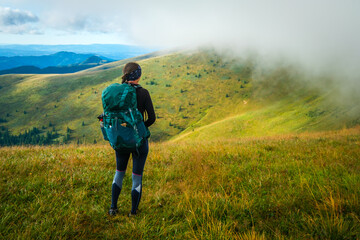 Woman with a backpack in the mountains. Velká Fatra mountain range, Slovakia