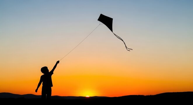 Joyful silhouette of child flying kite during golden hour sunset sky outdoors adventure