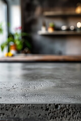 Close-up of a gray concrete countertop featuring a textured surface and a minimalist modern interior in the background with open shelves.