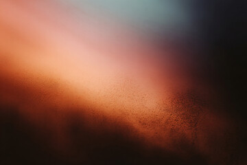 Fototapeta premium Blurry gradient with soft orange, red, and teal tones and grainy texture, creating an abstract atmospheric effect