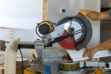 Craftsman uses circular saw to accurately cut wood in workshop, enhancing home renovation.