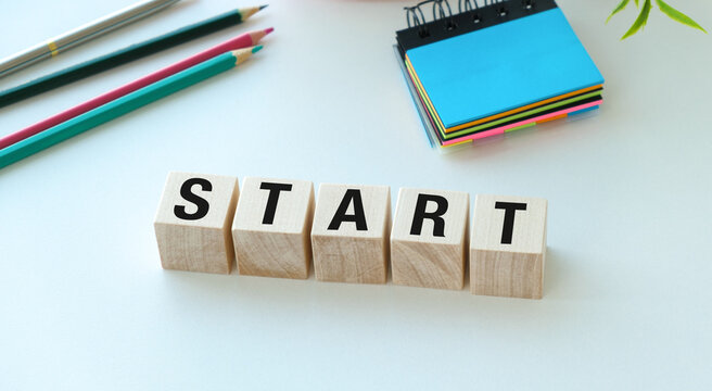 A wooden block with the word Start written on it
