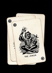 Vintage playing cards showing four of the same value isolated on a black background.