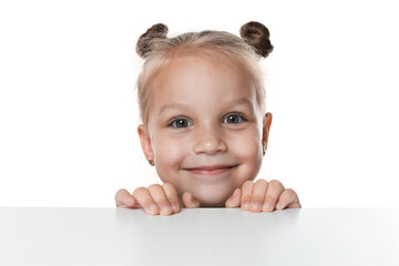 Curious little girl peeking over table against white background