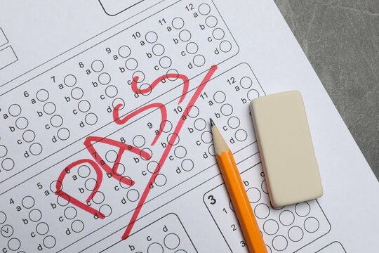 Answer sheet with word Pass, eraser and pencil on gray table, flat lay. Student passing exam