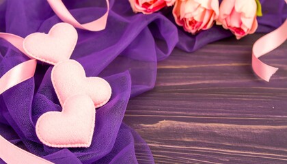 Pink felt hearts and roses on purple fabric and wood