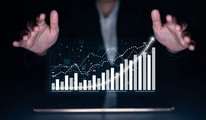 Hands hover above a laptop, presenting a digital graph showcasing financial growth and trends. This image represents modern analytics for business decision-making. Impute