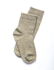 Two light beige socks lay flat against a white background, showcasing a simple, neutral design.