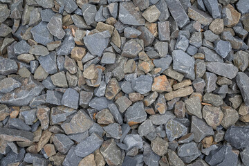 Close-up of broken stones piled up, about fist-sized.
