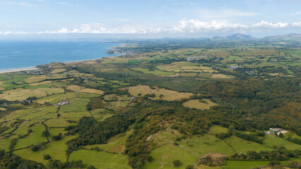 Snowdonia in Wales from an aerial view that shows mountains, trees and ocean, landscape