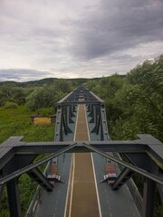 Vertical photo of the old railway bridge in Siekierki between Poland and Germany, a part of a popular bicycle route.