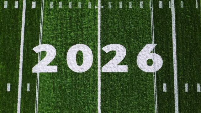 The numerals 2026 displayed in white coloration on the green turf of soccer field, representing athletic events in the summer