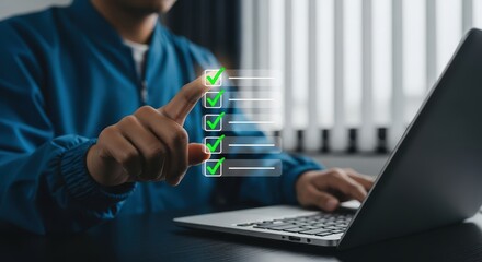 Person checking off a list on a digital screen with a laptop