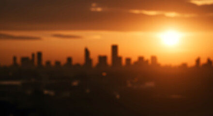 Fototapeta premium Beautifully Blurred Golden Sunset Sky Illuminating a Distant City Skyline