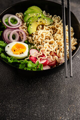 Vegetarian noodle bowl avocado, noodles, egg, vegetables tasty snack fresh delicious gourmet food background on the table rustic food top view copy space keto and paleo diet vegetarian food