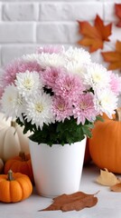 A beautifully decorated porch showcasing a white pumpkin and a wicker basket with a blanket, surrounded by autumn foliage