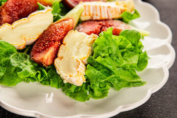 Salad figs, soft cheese, green leaf lettuce tasty snack fresh delicious gourmet food background on the table rustic food top view copy space keto and paleo diet vegetarian food