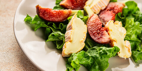 Salad figs, soft cheese, green leaf lettuce tasty snack fresh delicious gourmet food background on the table rustic food top view copy space keto and paleo diet vegetarian food