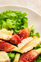 Salad figs, soft cheese, green leaf lettuce tasty snack fresh delicious gourmet food background on the table rustic food top view copy space keto and paleo diet vegetarian food