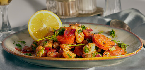 Chorizo and prawns in a sauce with herbs sprinkled on top.