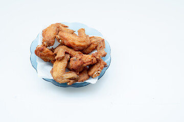 Crispy fried chicken wings served on a plate. Golden brown and crunchy, a popular snack or meal loved worldwide