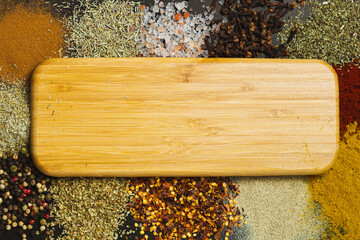 Frame made with different spices on dark background, flat lay. Space for text