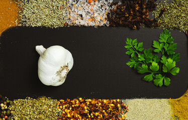 Frame made with different spices on dark background, flat lay. Space for text
