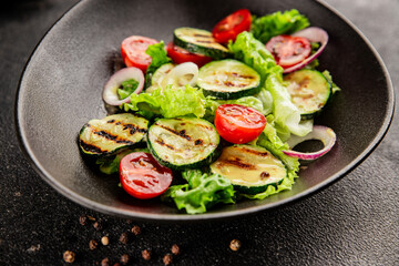 Salad grilled zucchini, tomato, lettuce tasty snack fresh delicious gourmet food background on the table rustic food top view copy space keto and paleo diet vegan and vegetarian food